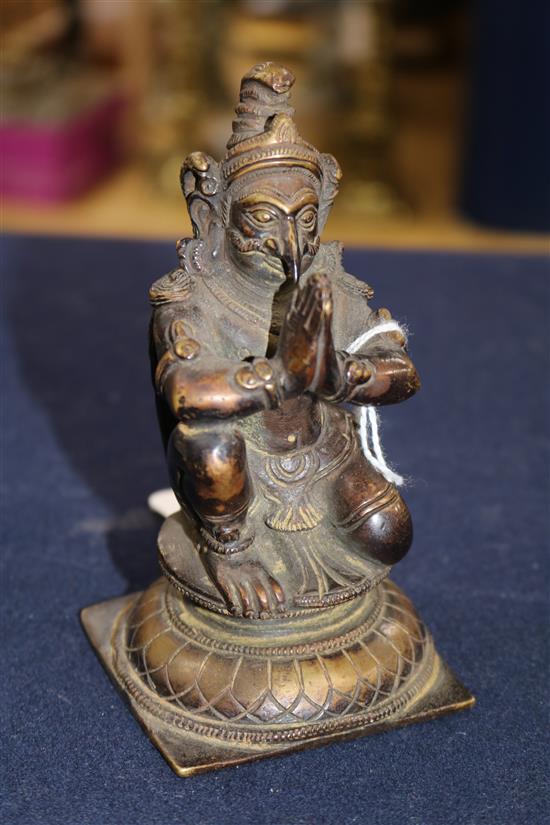 A Chinese celadon glazed tripod censer and a bronze figure of Garuda